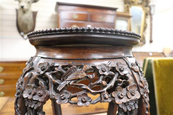 A pair of 19th century Chinese carved hardwood jardiniere stands